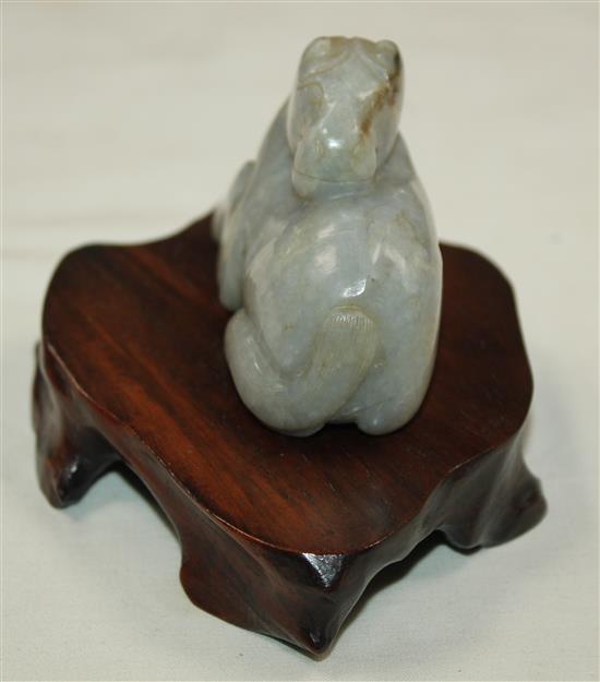 A Chinese mottled pale grey jade figure of a recumbent horse, probably Ming dynasty, 7.2cm, wood stand